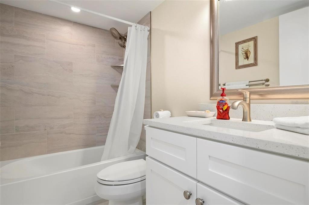1707 Pelican Cove Road, Unit 451 Sarasota, FL 34231 - Photo 15 of 24 a bathroom with a sink a toilet and a bathtub
