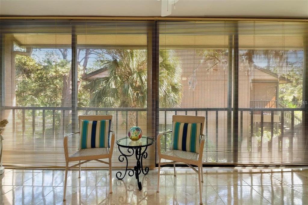 1707 Pelican Cove Road, Unit 451 Sarasota, FL 34231 - Photo 18 of 24 a view of a chairs and table in the balcony