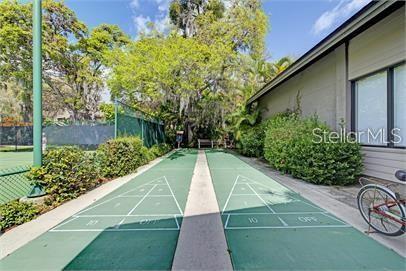 1707 Pelican Cove Road, Unit 451 Sarasota, FL 34231 - Photo 23 of 24 a view of small yard with large trees