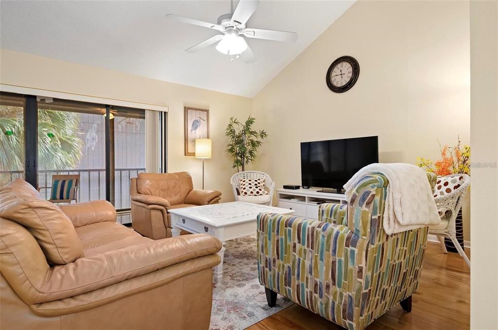 1707 Pelican Cove Road, Unit 451 Sarasota, FL 34231 - Photo 8 of 24 a living room with furniture a flat screen tv and a window