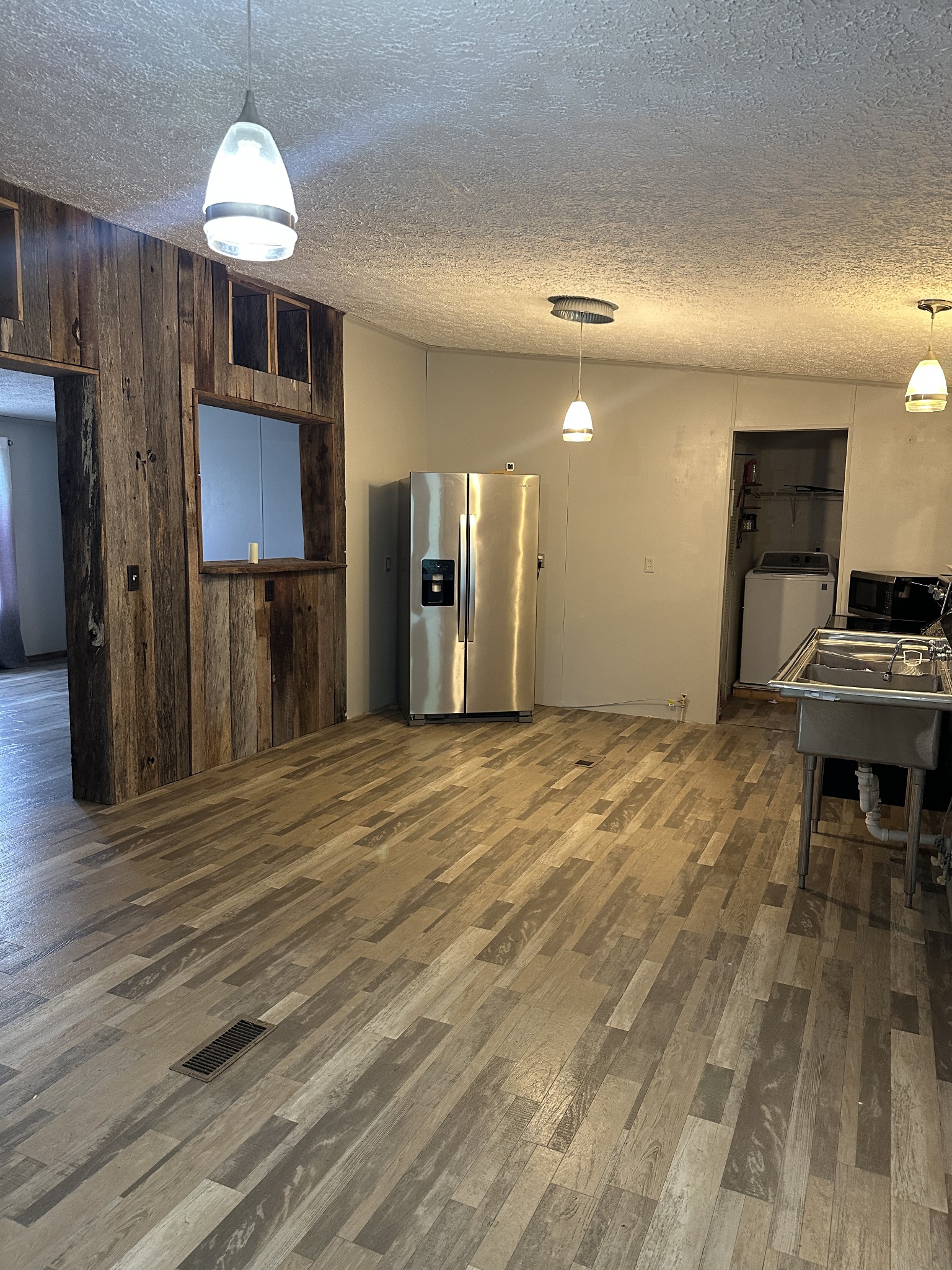 104 Limo View Lane Hohenwald, TN 38462 - Photo 11 of 67 a view of a livingroom with a furniture chandelier and wooden floor