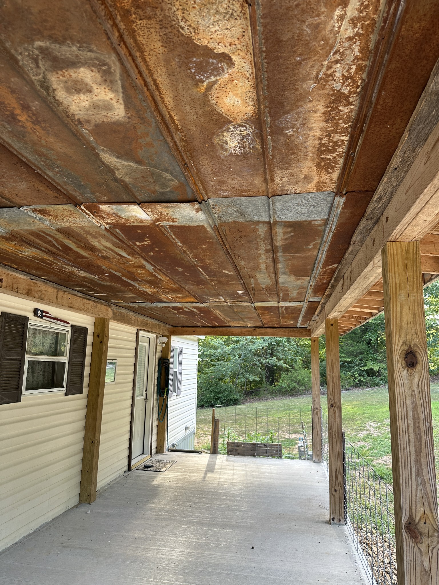 104 Limo View Lane Hohenwald, TN 38462 - Photo 7 of 67 a view of a porch with furniture and a parking space