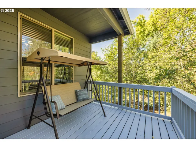 a view of balcony with wooden floor and furniture