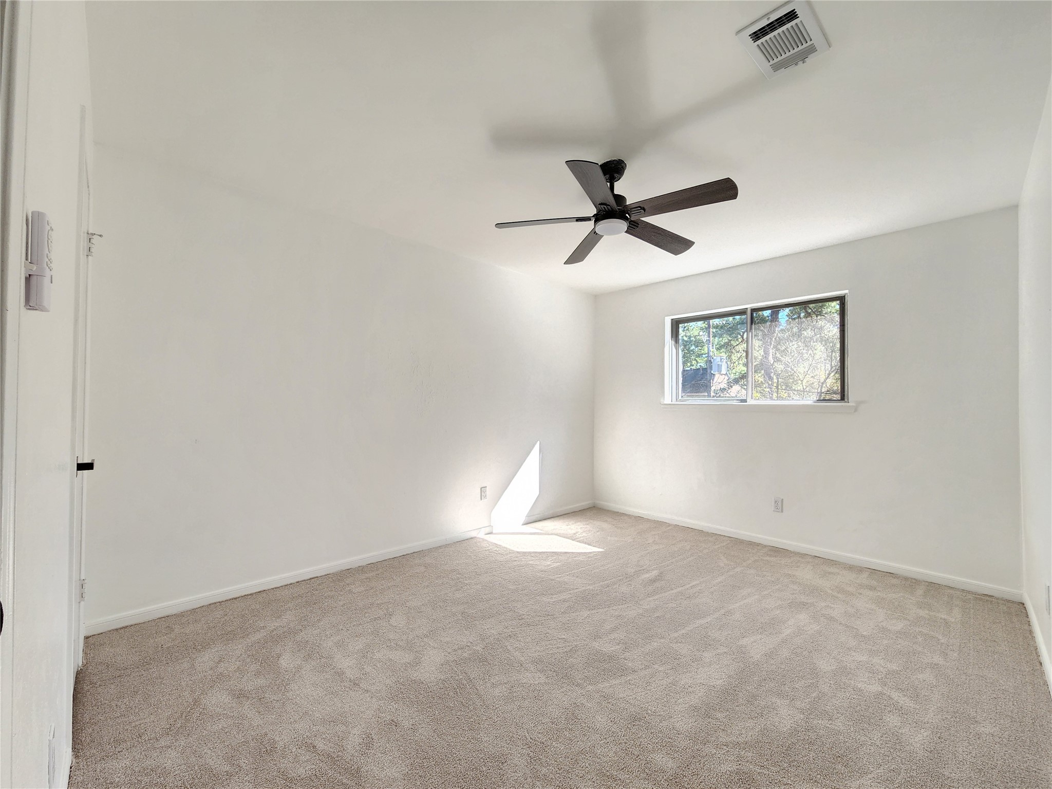 5411 Cobble Lane Spring, TX 77379 - Photo 13 of 31 an empty room with a window and a fan