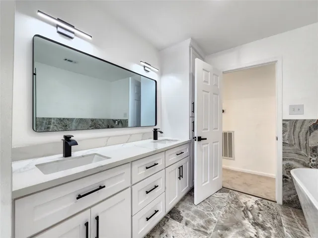 an empty room with a ceiling fan and a window