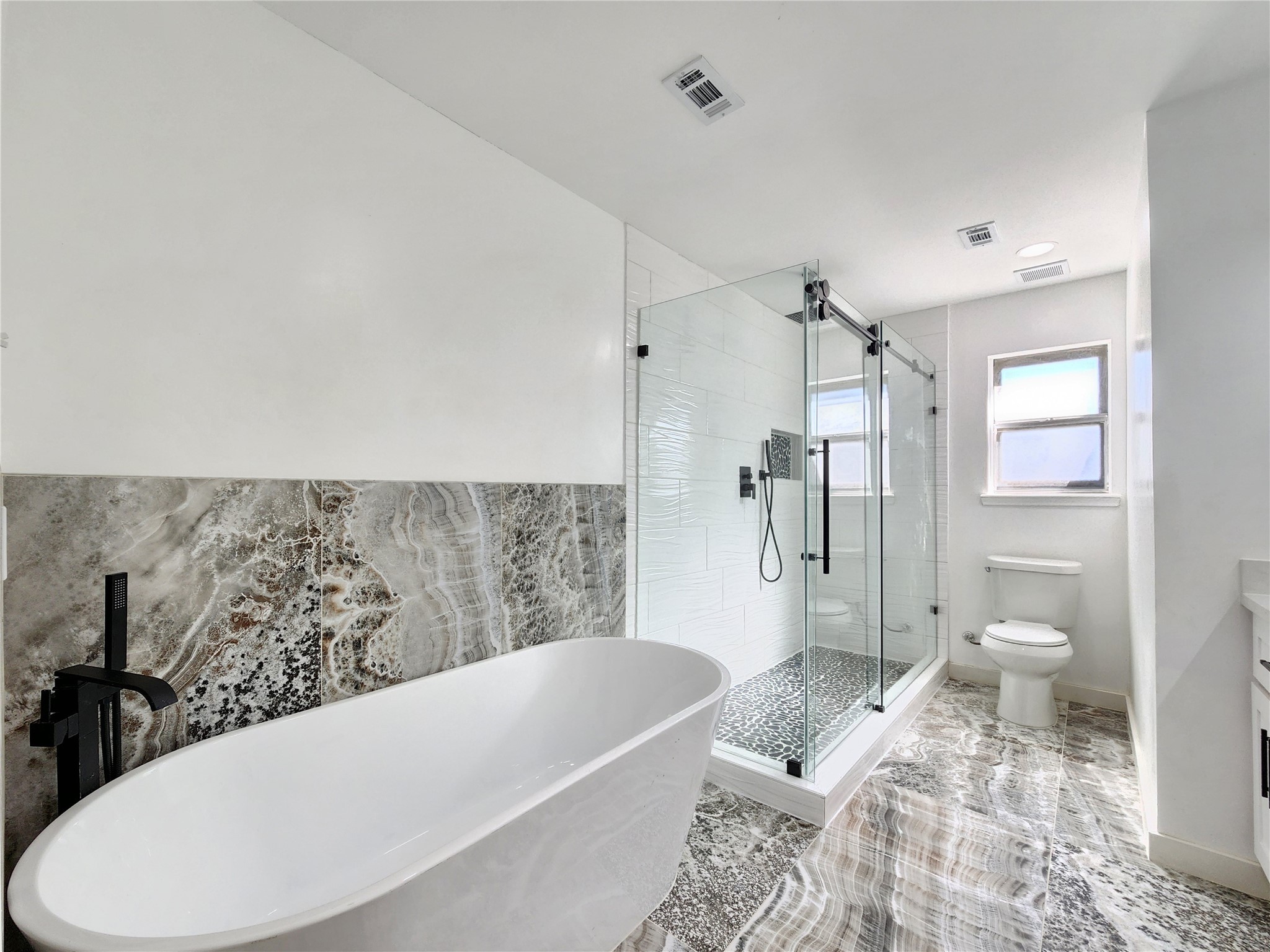 5411 Cobble Lane Spring, TX 77379 - Photo 15 of 31 a bathroom with a bathtub and toilet