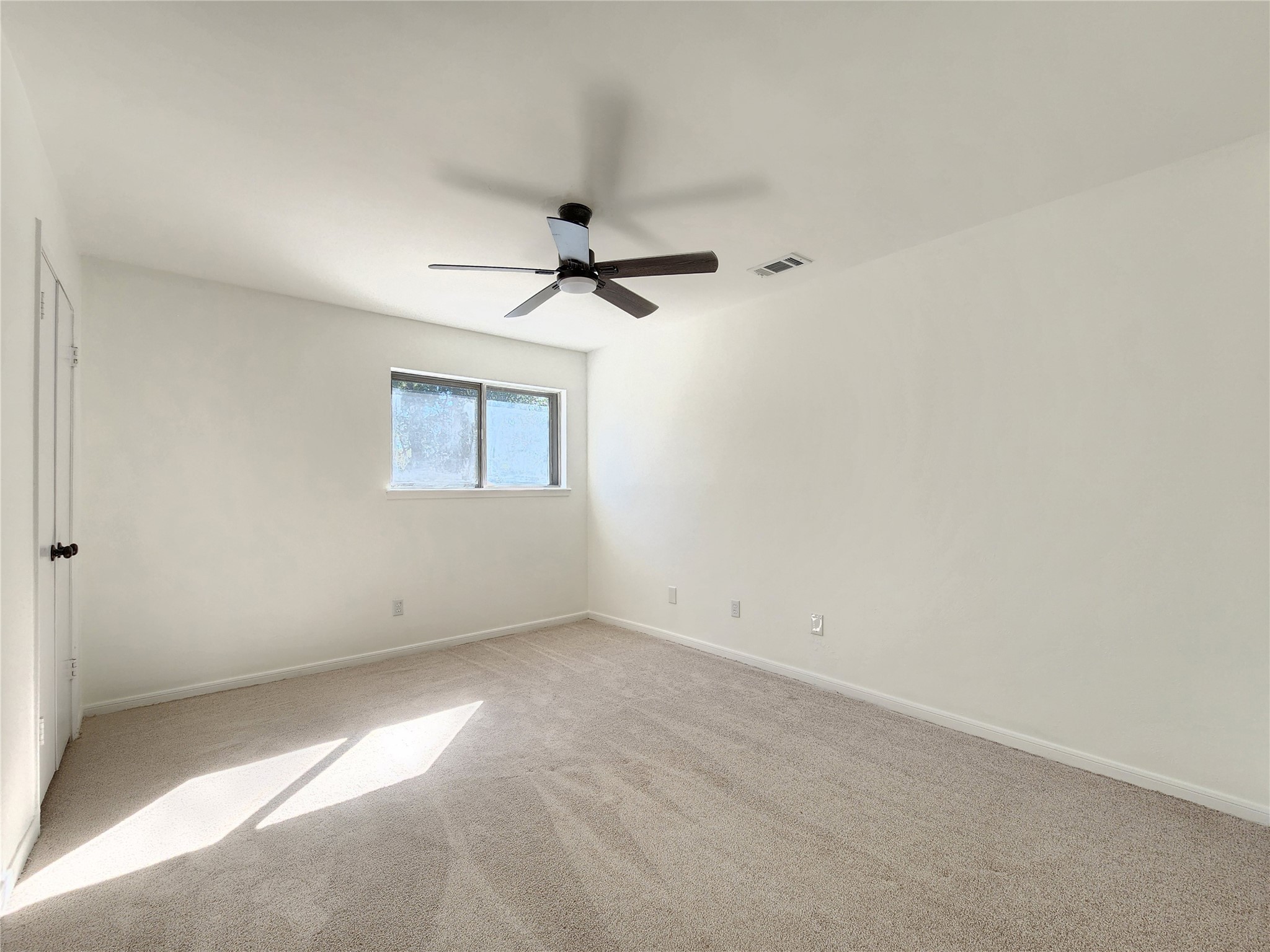 5411 Cobble Lane Spring, TX 77379 - Photo 16 of 31 an empty room with a ceiling fan and a window