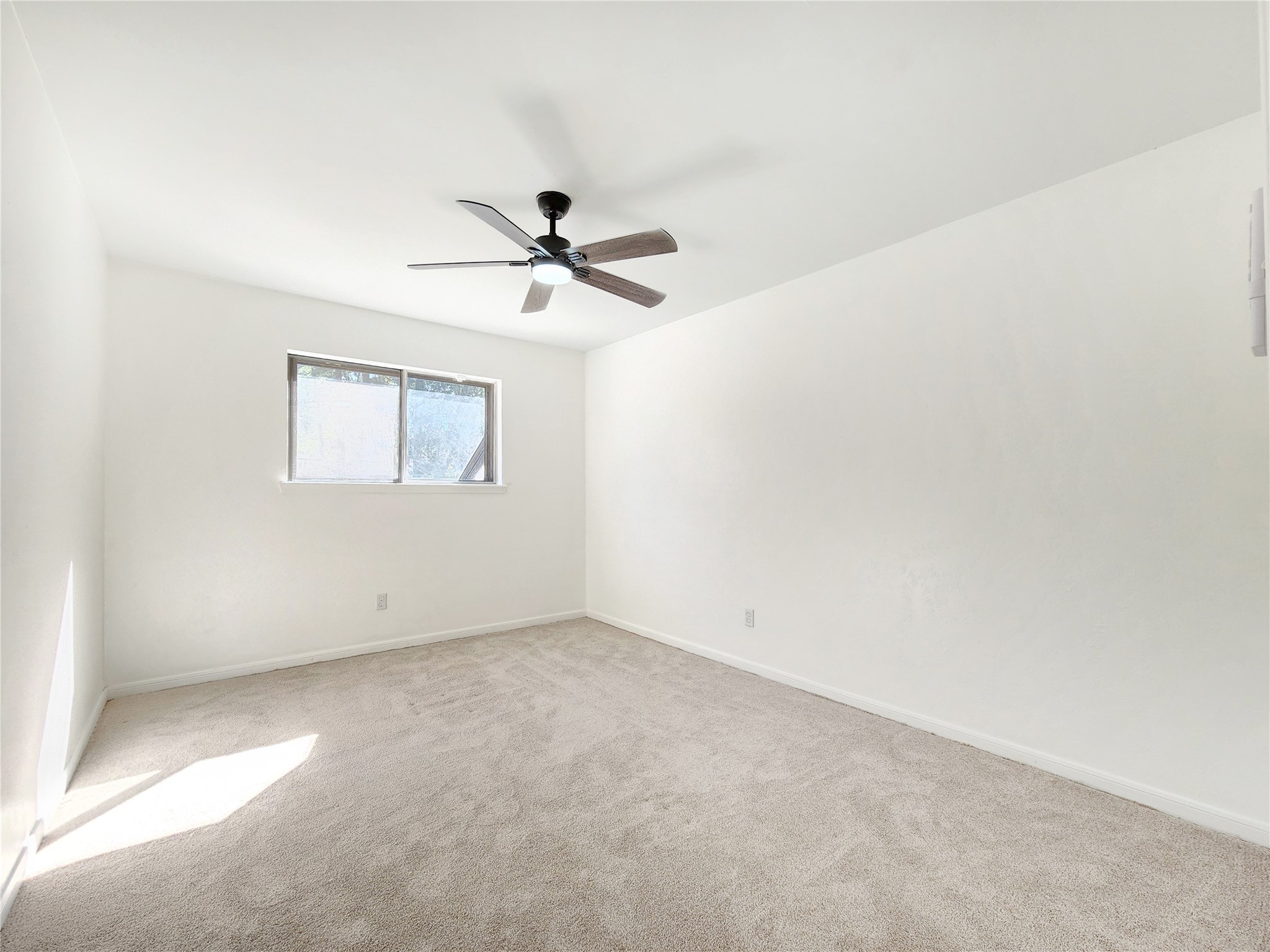 5411 Cobble Lane Spring, TX 77379 - Photo 17 of 31 an empty room with a window and a chandelier fan