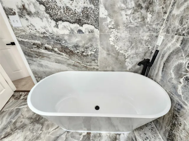 a bathroom with a bathtub and a sink