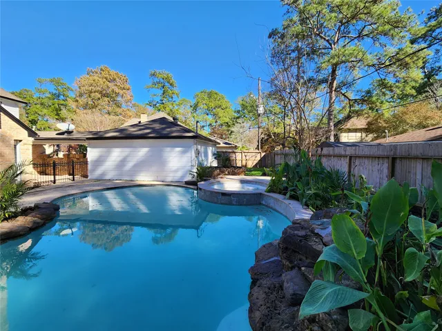 a view of a swimming pool with a yard