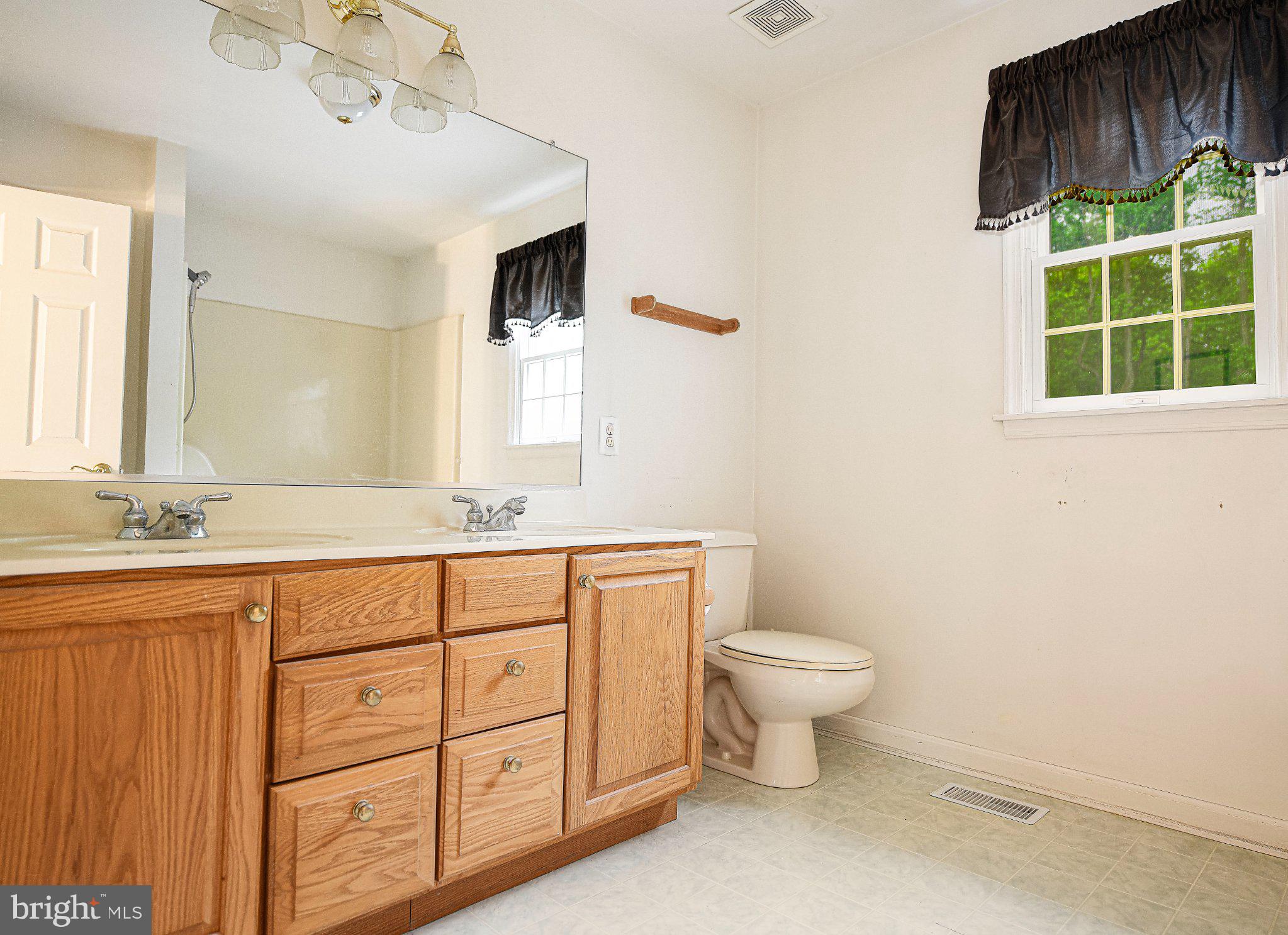 711 Gilbert Road Aberdeen, MD 21001 - Photo 19 of 54 a bathroom with a toilet sink and mirror