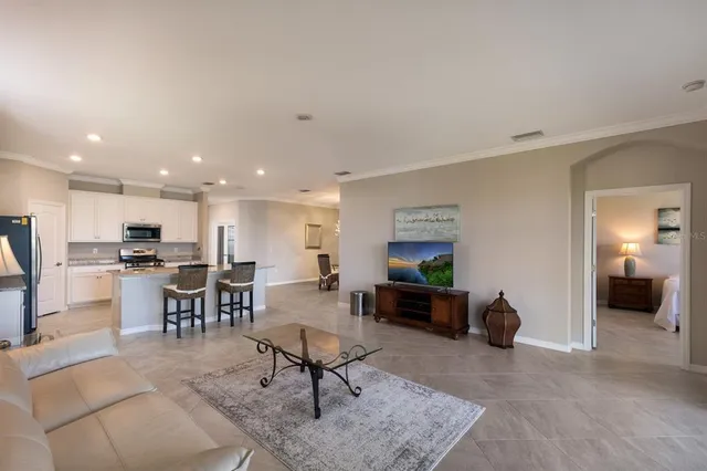 a living room with furniture and kitchen view