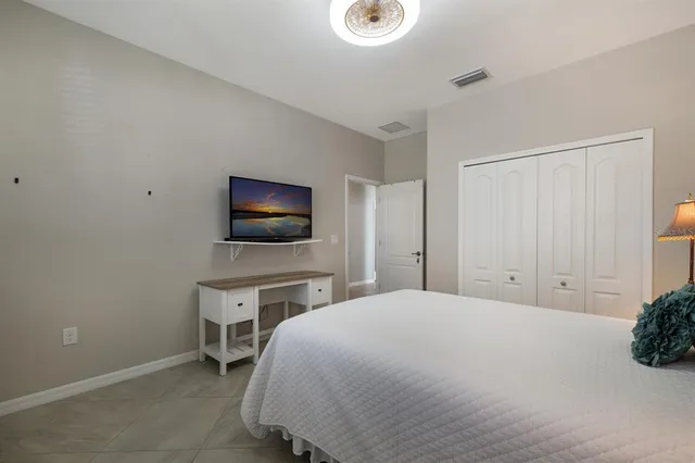 a bedroom with a bed and a flat screen tv