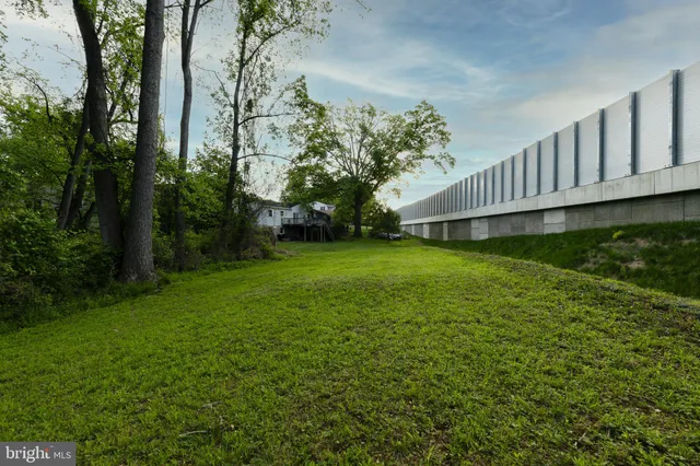 a view of a backyard with large trees