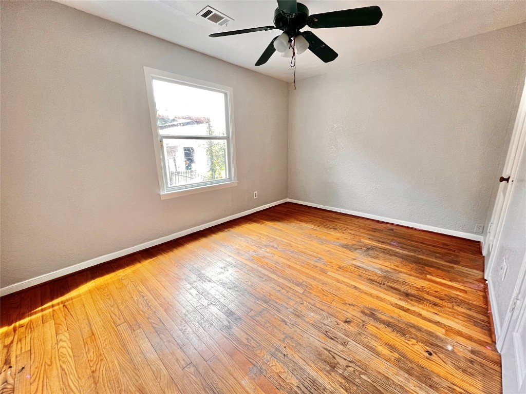 914 Bunton Street Houston, TX 77009 - Photo 12 of 15 an empty room with wooden floor fan and windows