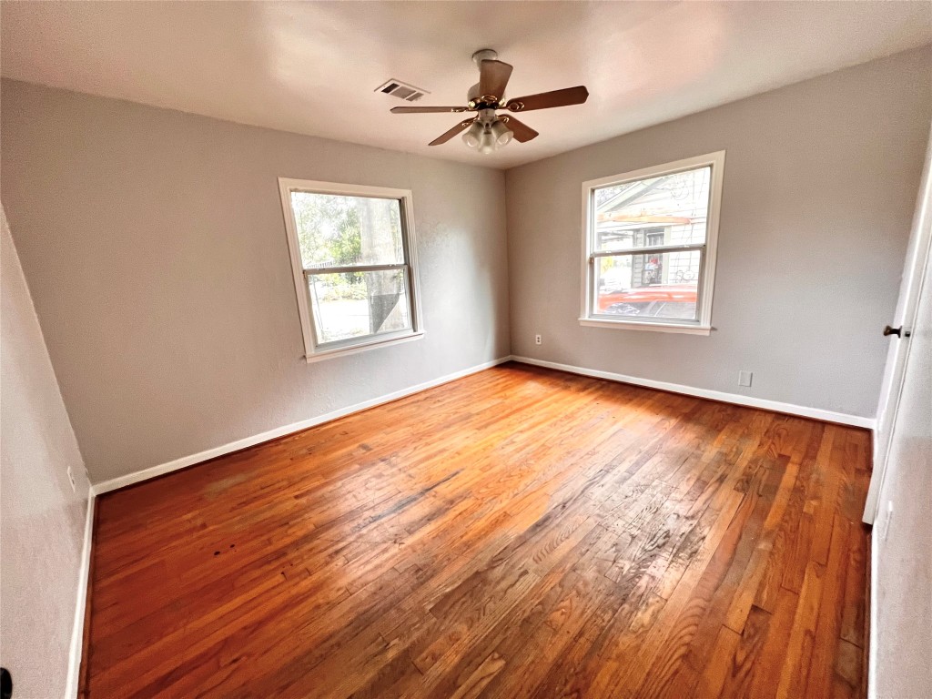 914 Bunton Street Houston, TX 77009 - Photo 13 of 15 a view of an empty room with wooden floor and a window