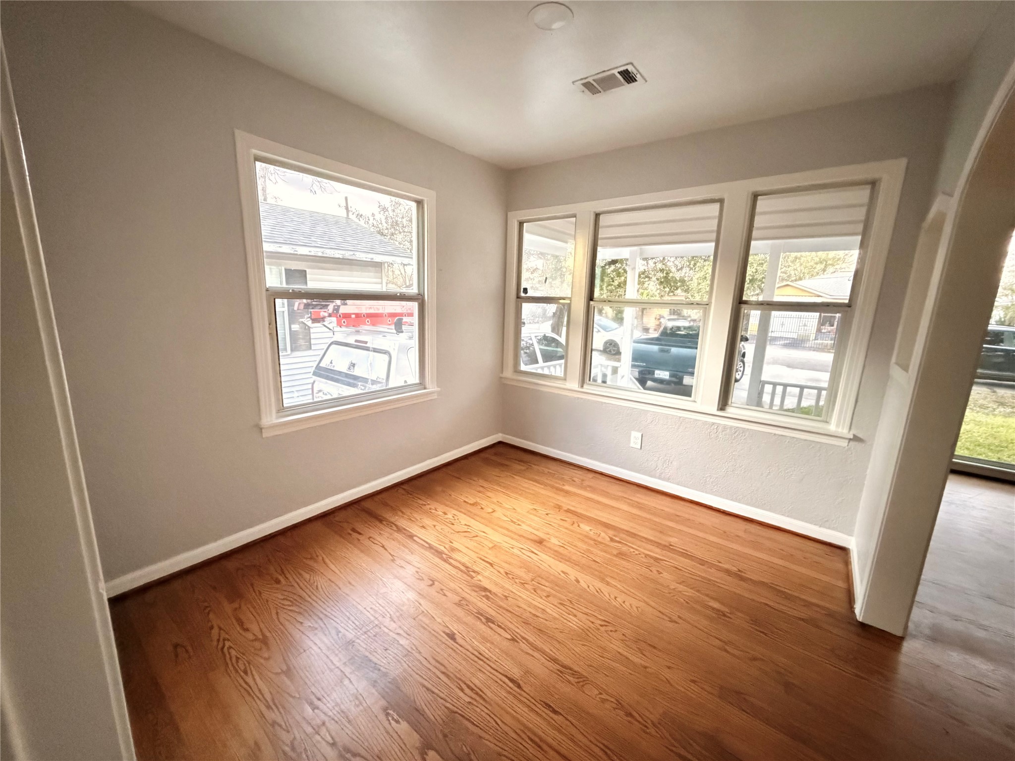 914 Bunton Street Houston, TX 77009 - Photo 5 of 15 a view of an empty room with wooden floor and a window