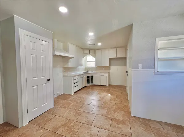 a view of a kitchen with electric appliances
