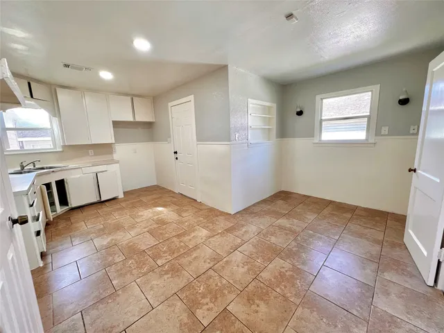 a view of a kitchen with furniture and a window