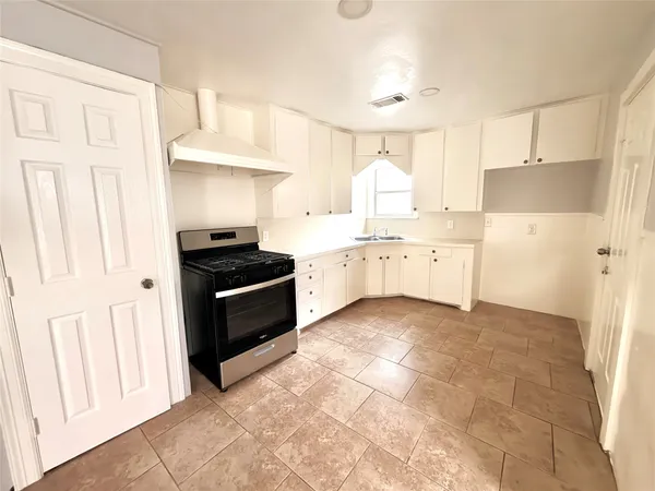 a kitchen with a stove a sink and a refrigerator