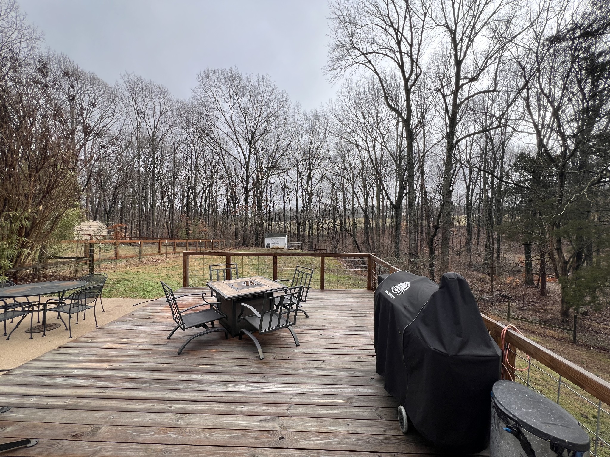 2001 Cherokee Trail Springfield, TN 37172 - Photo 17 of 22 a view of a roof deck with table and chairs a barbeque with wooden floor and fence