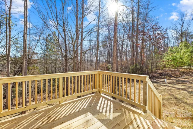 a view of wooden deck and trees