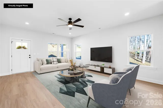 a living room with furniture wooden floor and a flat screen tv