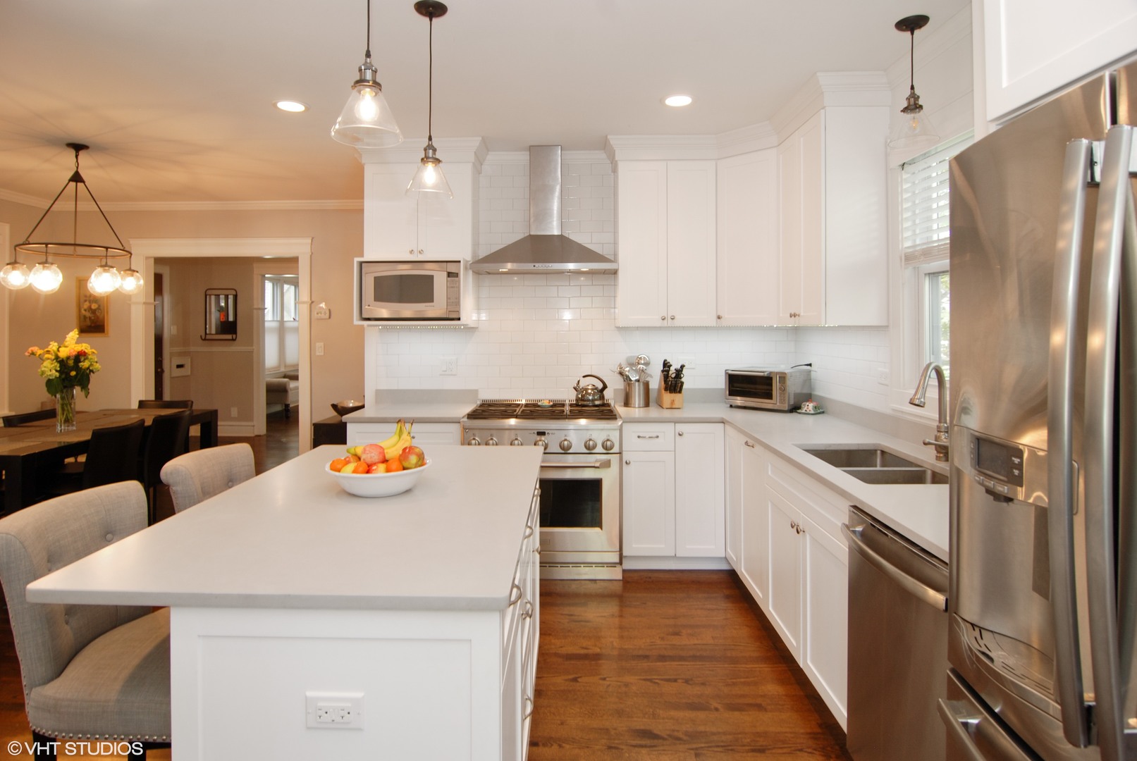 349 Nuttall Road Riverside, IL 60546 - Photo 5 of 25 a kitchen with stainless steel appliances granite countertop a sink a stove a refrigerator and island with wooden floor