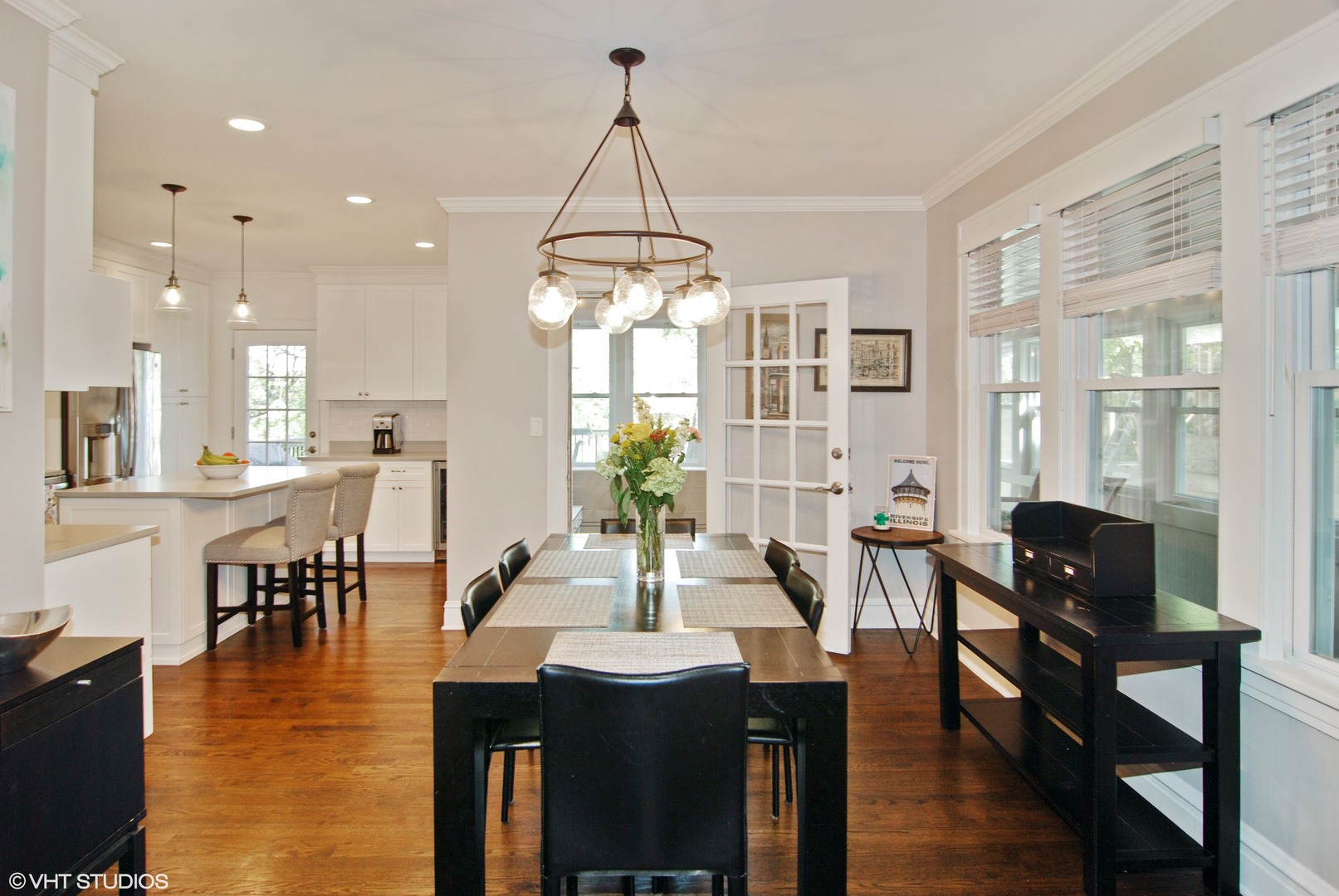 349 Nuttall Road Riverside, IL 60546 - Photo 7 of 25 a dining room with wooden floor a chandelier a wooden table and chairs