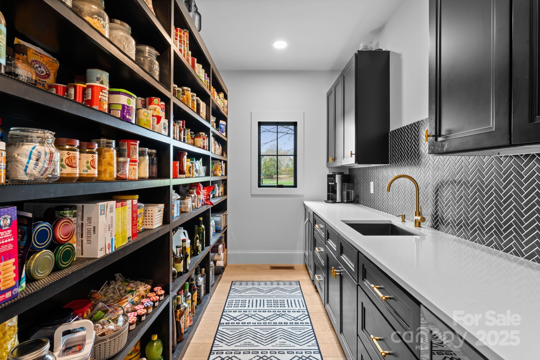 1575 Shinnville Road Cleveland, NC 27013 - Photo 19 of 47 a kitchen with stainless steel appliances granite countertop a lot of cabinets and a wooden floor