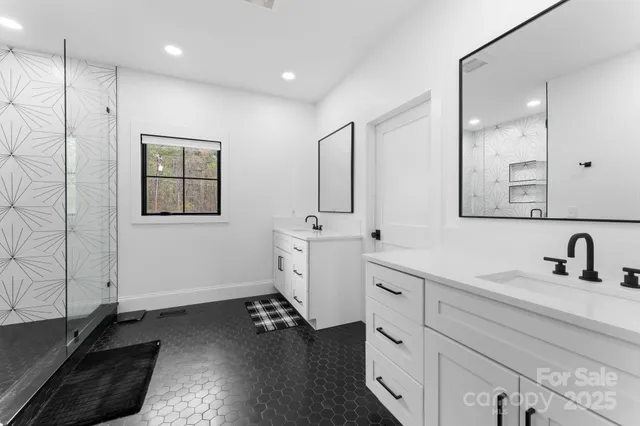 a bathroom with a double vanity sink and mirror