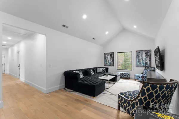 a living room with furniture window and flat screen tv