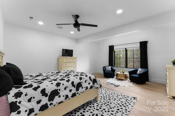 a bedroom with a large bed and a window