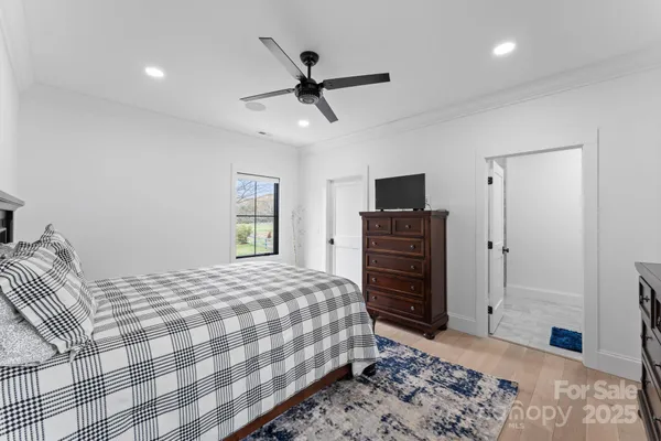 a bedroom with a bed and a television