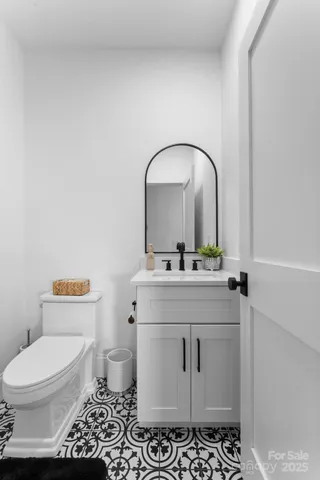 a bathroom with a sink toilet and vanity