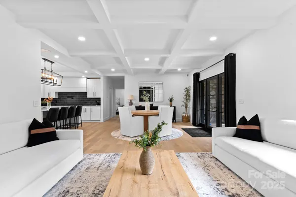 a living room with furniture and view of kitchen