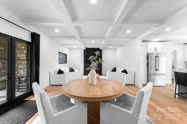 a dining room with furniture and wooden floor