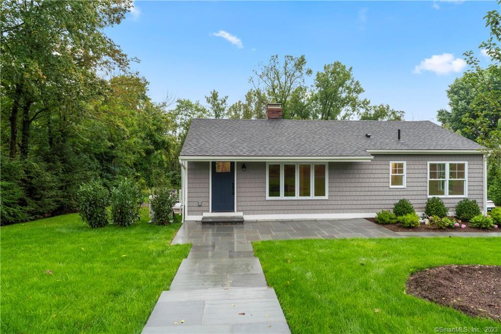 a front view of a house with a garden
