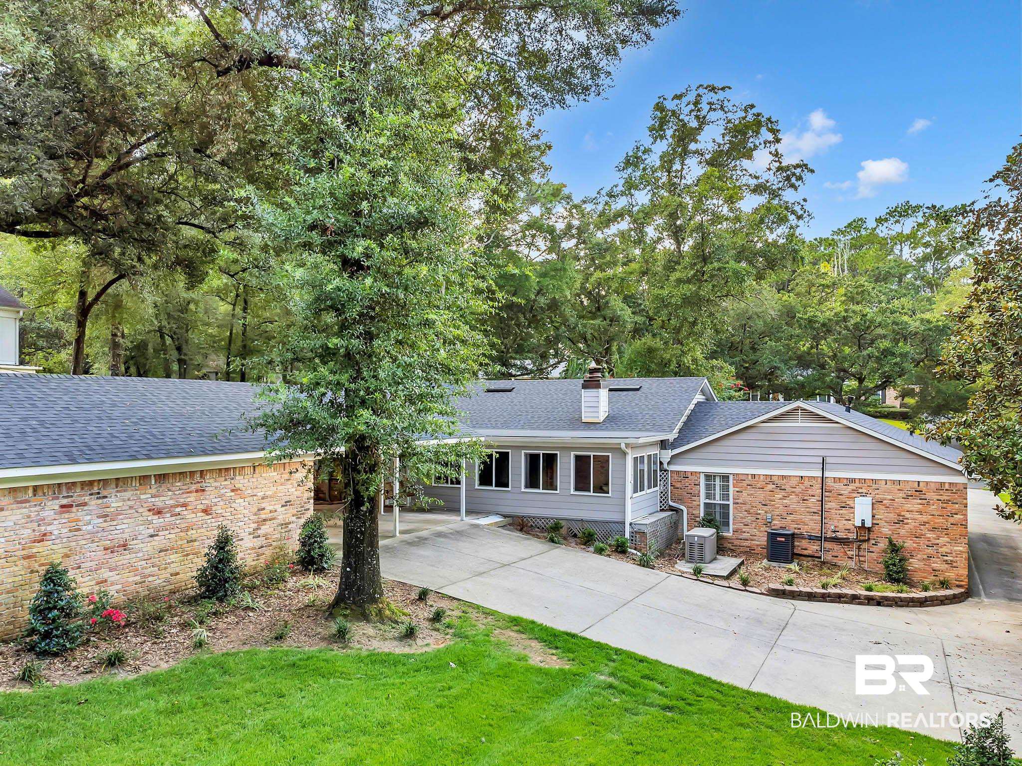 309 West Brandy Run Road Mobile, AL 36608 - Photo 96 of 100 View of front of property with brick siding, driveway, a chimney, and a shingled roof