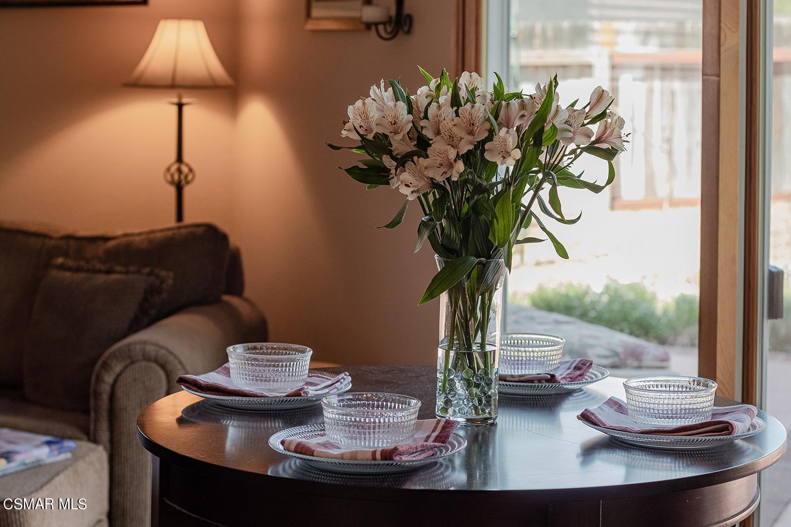 13339 Peach Hill Road Moorpark, CA 93021 - Photo 16 of 45 a vase of flowers sitting on a table with a vase