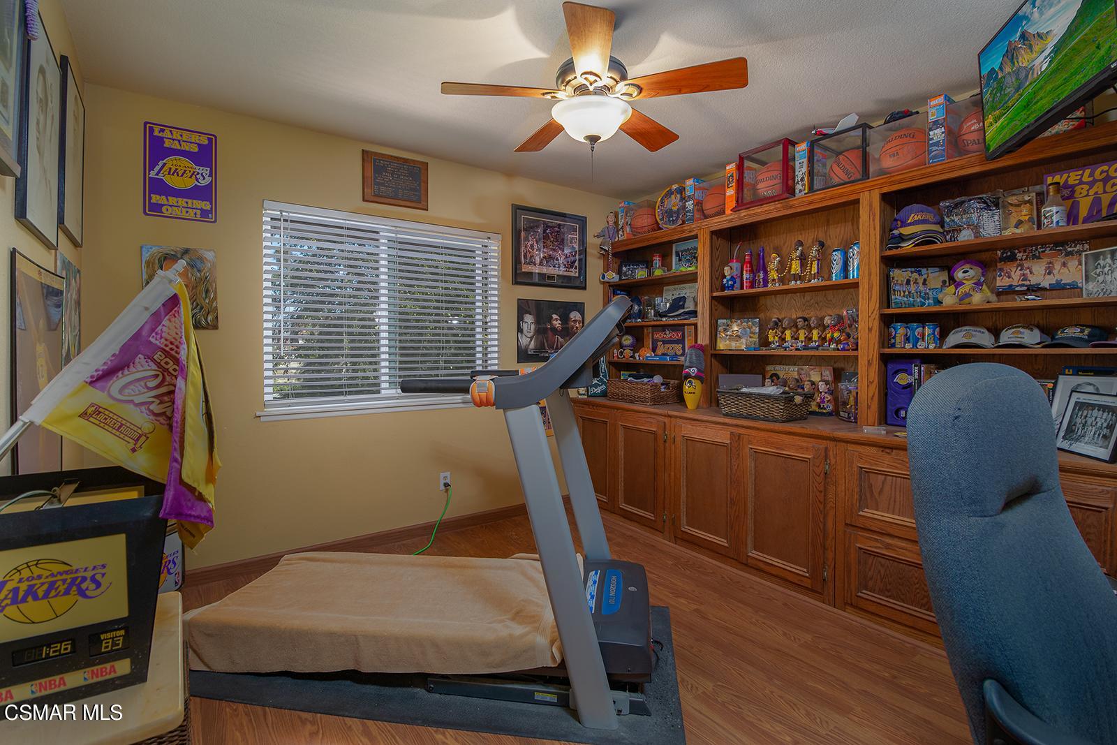 13339 Peach Hill Road Moorpark, CA 93021 - Photo 20 of 45 a bedroom with a bed and a bookshelf
