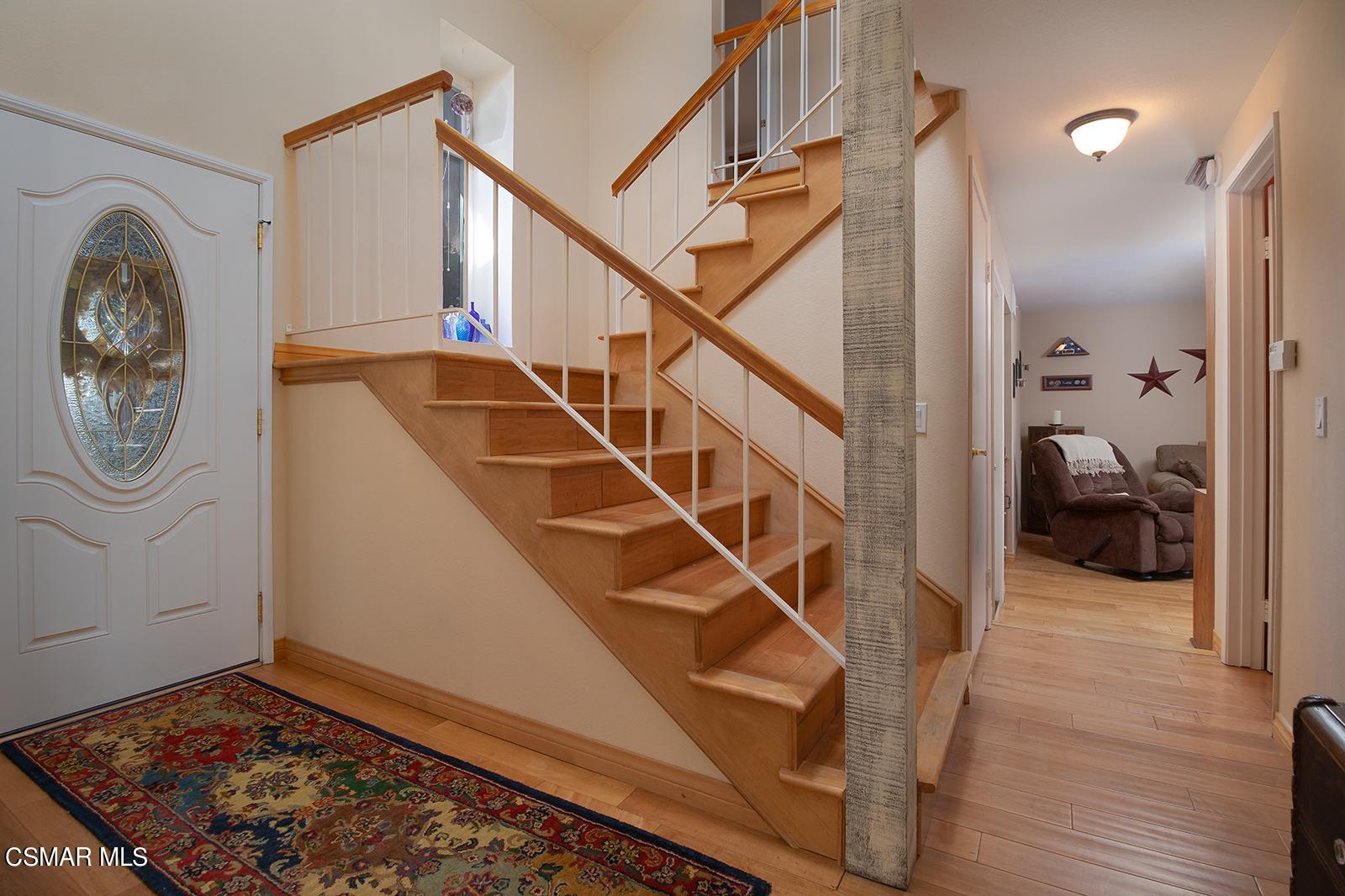 13339 Peach Hill Road Moorpark, CA 93021 - Photo 3 of 45 a view of entryway with wooden floor and a front door