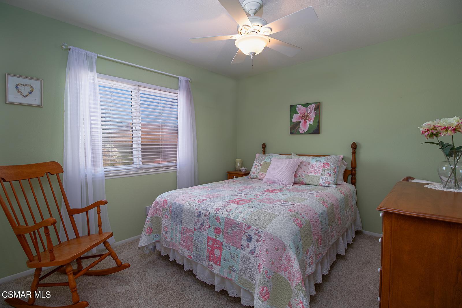 13339 Peach Hill Road Moorpark, CA 93021 - Photo 22 of 45 a bedroom with a bed and a chandelier