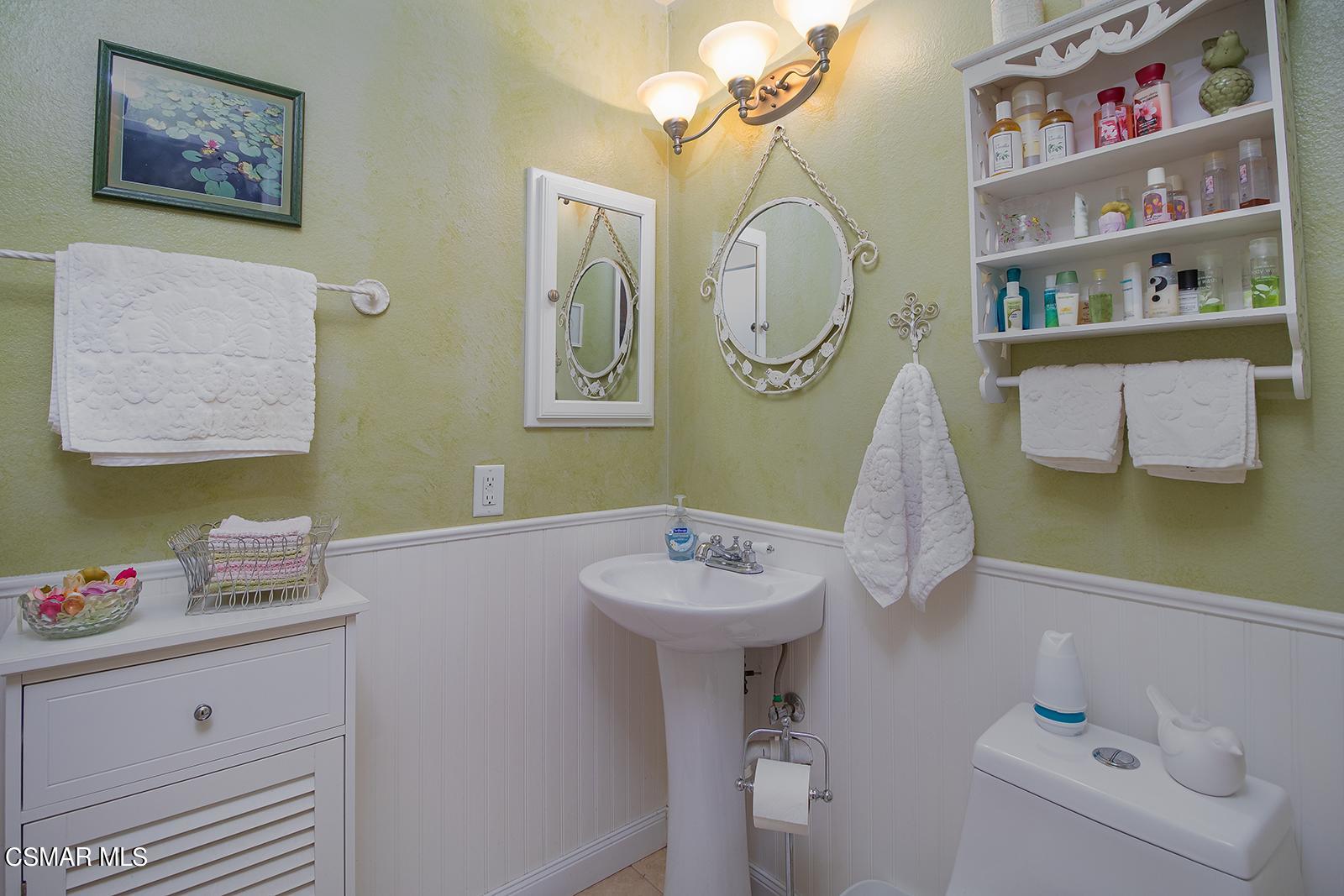 13339 Peach Hill Road Moorpark, CA 93021 - Photo 23 of 45 a bathroom with a sink mirror and vanity
