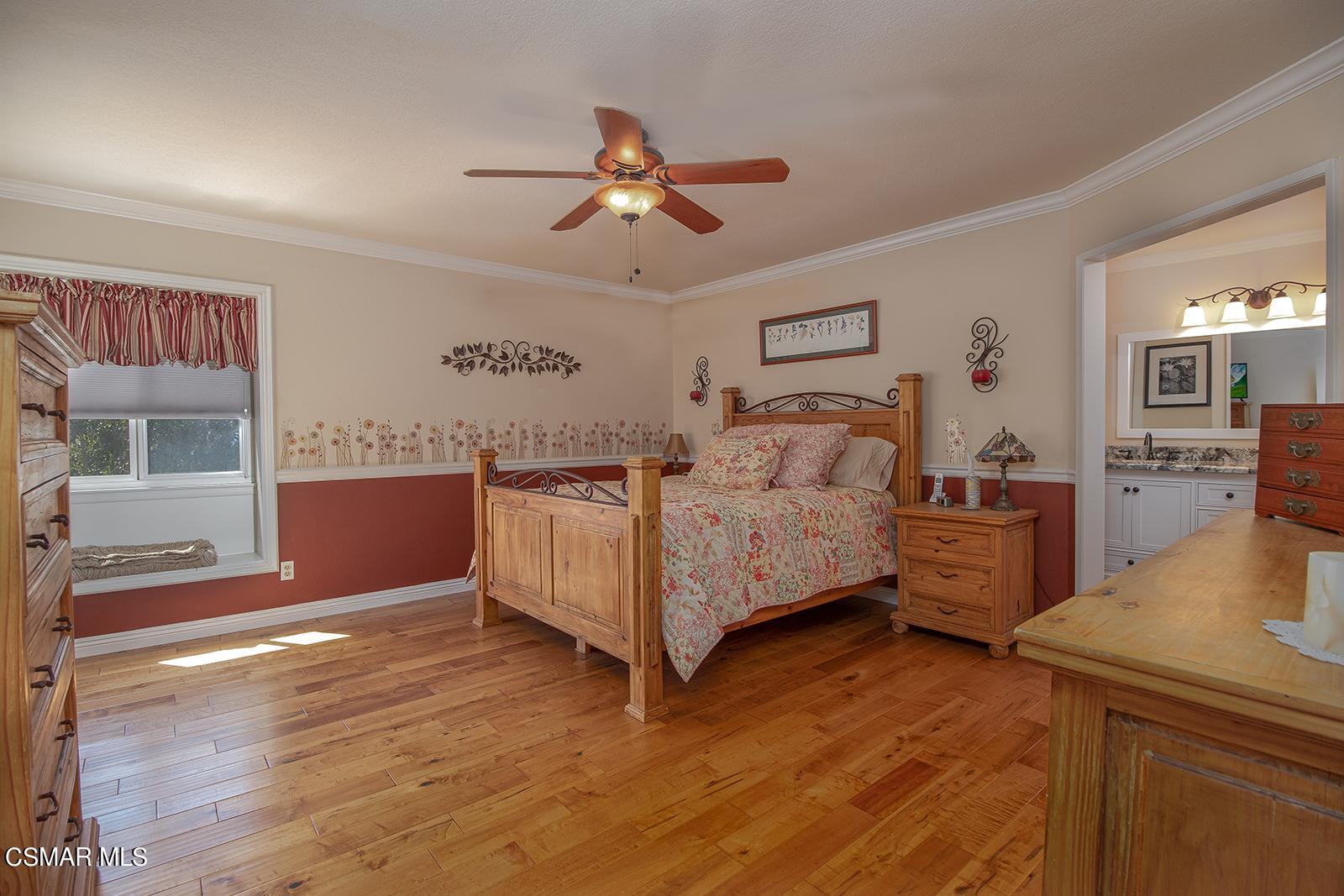 13339 Peach Hill Road Moorpark, CA 93021 - Photo 24 of 45 a bed room with a bed and a chandelier