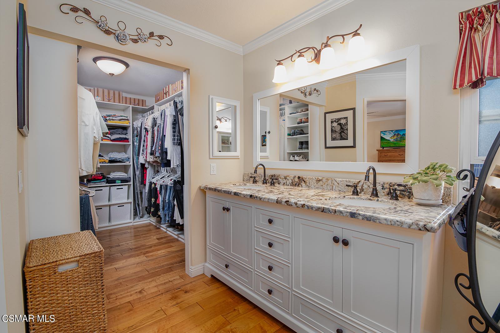 13339 Peach Hill Road Moorpark, CA 93021 - Photo 26 of 45 a spacious bathroom with a granite countertop sink and a mirror