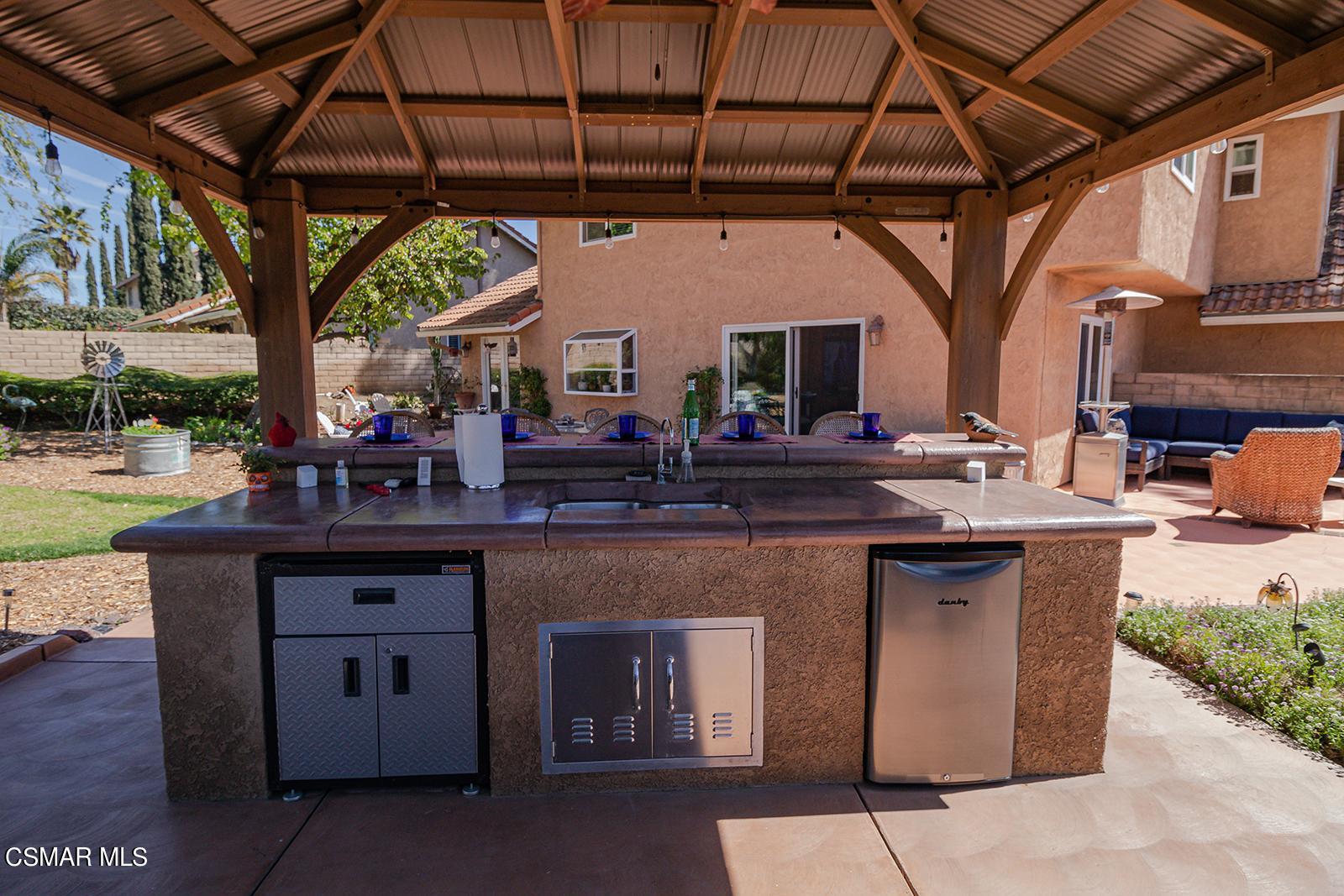 13339 Peach Hill Road Moorpark, CA 93021 - Photo 38 of 45 a open kitchen with stainless steel appliances granite countertop a sink a stove and a wooden floors