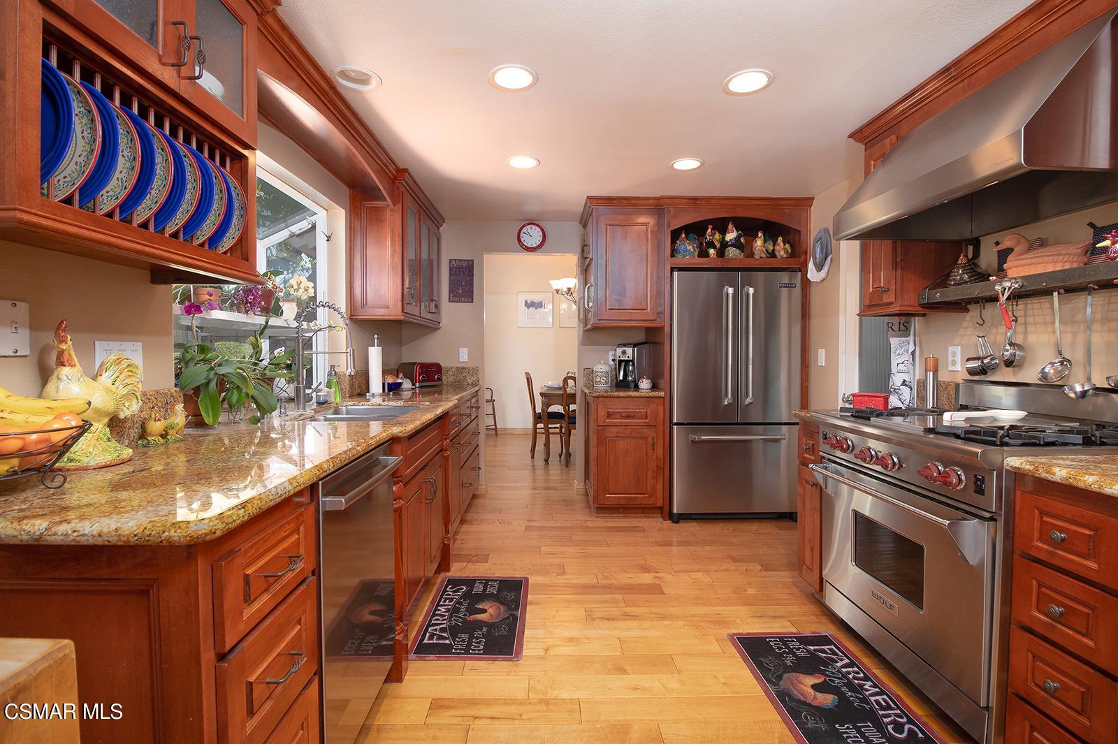 13339 Peach Hill Road Moorpark, CA 93021 - Photo 10 of 45 a kitchen with stainless steel appliances granite countertop a refrigerator a stove and a sink