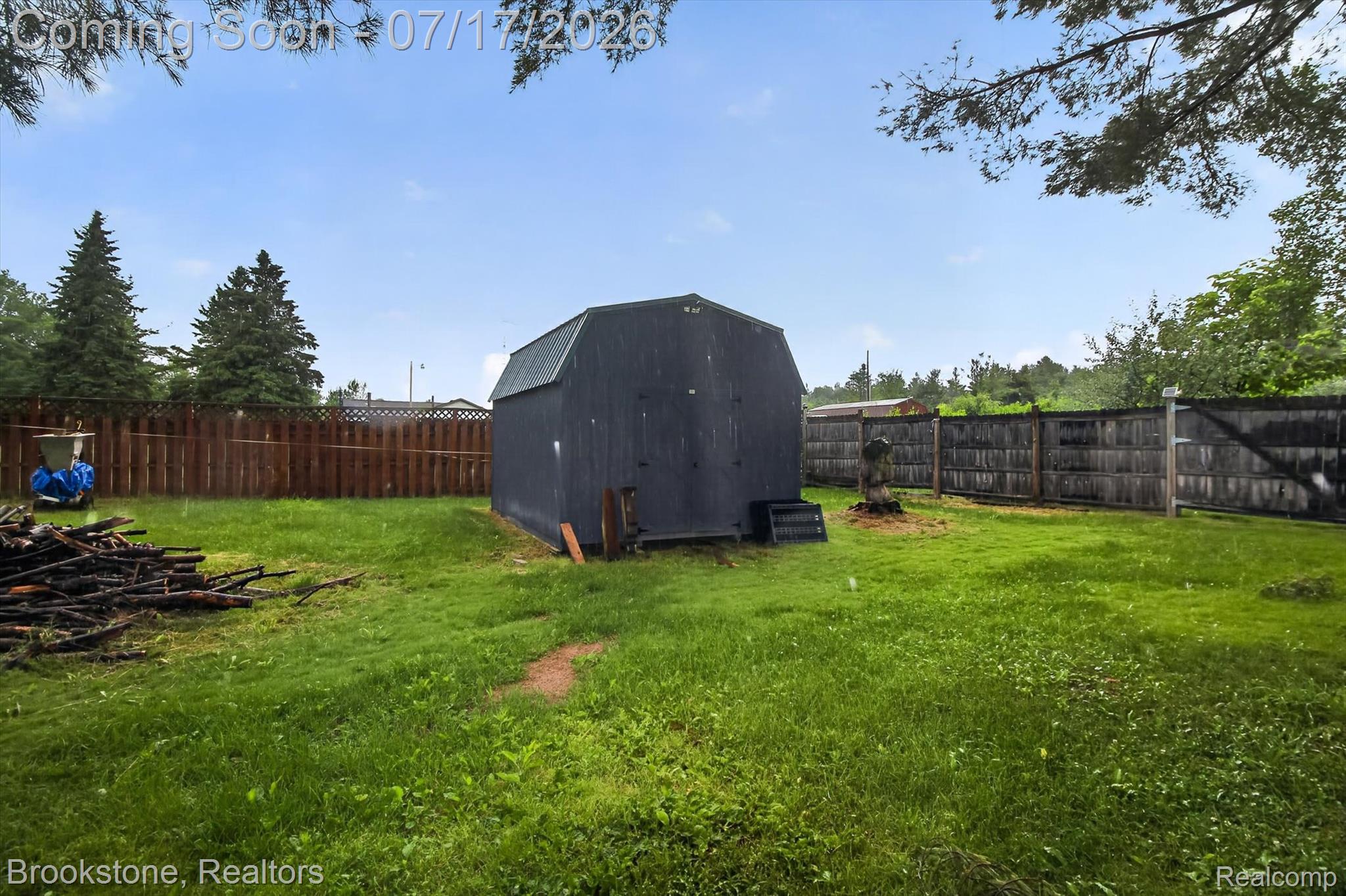 22709 Pleasant Valley Road Hillman, MI 49746 - Photo 35 of 42 Detached storage shed with a gambrel roof and dark siding