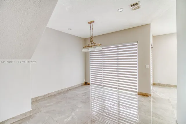 a kitchen with stainless steel appliances granite countertop a stove and a refrigerator